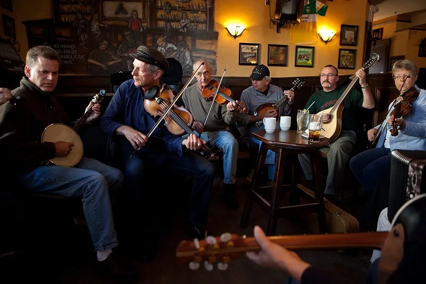 Photo of fiddlers in a session at the Old Triangle.